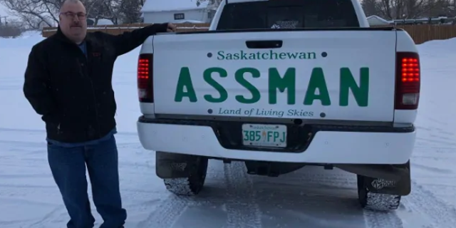 David Assman standing next to his pickup truck with a decal bearing his last name.