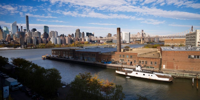 FILE- In this Nov. 7, 2018, file photo, a rusting ferryboat is docked next to an aging industrial warehouse on Long Island City's Anable Basin in the Queens borough of New York. Amazon's decision to pull out of building a headquarters in the city follows a backlash against the tech giant's plan.