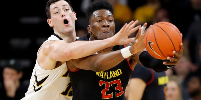  El delantero de Iowa Ryan Kriener, izquierda, trata de robarle el balón al delantero de Maryland Bruno Fernando durante la segunda mitad de un juego de baloncesto universitario de la NCAA el 19 de febrero de 2019 en Iowa City, Iowa. 