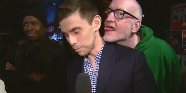 A Canadian actor and comedian was seen in a video appearing to lick a reporter during a live hit.