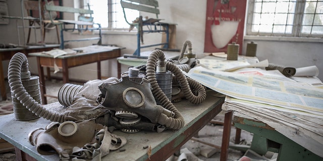 Gas masks left on a school desk. (Credit: Media Drum World)