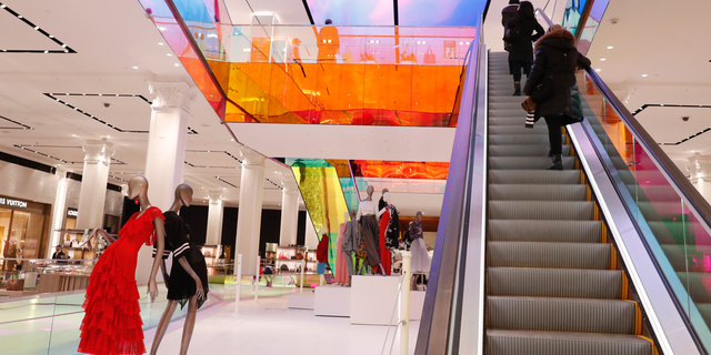 FILE- In this Wednesday, Feb. 20, 2019, file photo shoppers ride the escalator at Saks Fifth Avenue's flagship midtown Manhattan store, in New York. On Tuesday, Feb. 26, the Conference Board releases its February index on U.S. consumer confidence. (AP Photo/Kathy Willens, File)