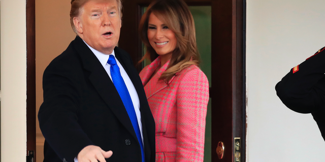 President Donald Trump with first lady Melania Trump, responds to reporters questions as he bid farewell to visiting Colombian President Ivan Duque and his wife Maria Juliana Ruiz Sandoval, outside the West Wing of the White House in Washington, Wednesday, Feb. 13, 2019. (AP Photo/Manuel Balce Ceneta)