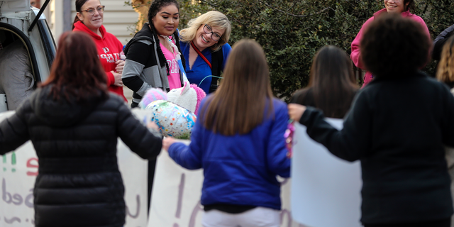 In this Jan. 31, 2019 photo, Zei Uwadia, second from left, is greeted by supporters as she returns to her Wichita, Kan., home, after spending the last 457 days at Children's Mercy hospital in Kansas City following her collapse from a lung condition. Uwadia died in her home on Tuesday, Feb. 12, 2019, her mother said. She was 17. (Travis Heying/The Wichita Eagle via AP)