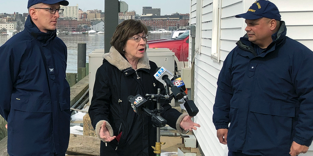 U.S. Sen. Susan Collins, R-Maine, is flanked by Coast Guard Capt. Brian LeFebvre, left, and Rear Adm. Andrew Tiongson, right, as she addresses reporters after the ribbon-cutting at a U.S. Coast Guard regional command center Wednesday, Feb. 20, 2019, in South Portland, Maine. Collins said that she would vote for a congressional resolution disapproving of President Donald Trump's emergency declaration to build a wall on the southern border. She is the first Republican senator to publicly express support for such a resolution. (AP Photo/David Sharp)