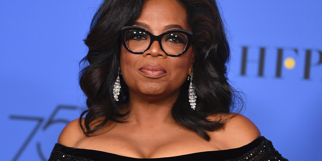 FILE - In this Jan. 7, 2018 file photo, Oprah Winfrey poses in the press room with the Cecil B. DeMille Award at the 75th annual Golden Globe Awards in Beverly Hills, Calif. Winfrey will interview two men who say Michael Jackson sexually abused them as boys immediately after a documentary on the men. HBO and the Oprah Winfrey Network announced Wednesday that “After Neverland,” will air on both channels Monday at 10 p.m. Eastern and Pacific. (Photo by Jordan Strauss/Invision/AP, File)