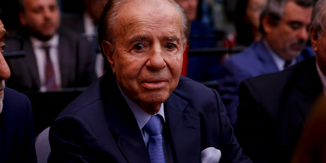 Former Argentine President Carlos Menem sits at a court house in Buenos Aires, Argentina, Thursday, Feb. 28, 2019. The court is expected to give its verdict on the trial against Menem, several former officials, a former federal judge and two former prosecutors, accused of hampering the investigation of the attack on a Jewish center in Buenos Aires in 1994. (AP Photo/Natacha Pisarenko)