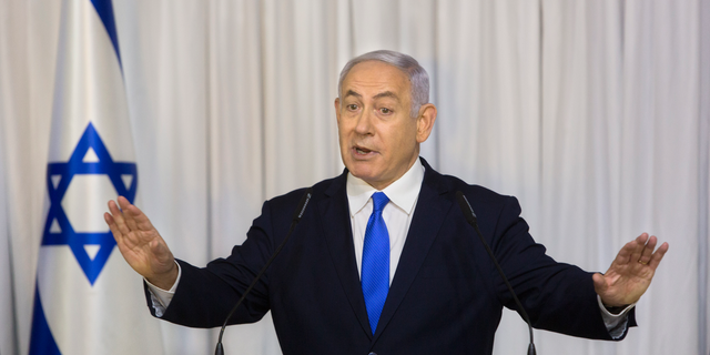 FILE - In this Thursday, Feb. 21, 2019 file photo, Israeli Prime Minister Benjamin Netanyahu delivers a statement in Ramat Gan, Israel. The attorney general's decision on whether to indict Netanyahu on a series of corruption allegations is expected to be delivered Thursday, Feb. 28, 2019. Avichai Mandelblit is expected to announce his decision after more than two years of intense investigations and deliberations. (AP Photo/Sebastian Scheiner, File)