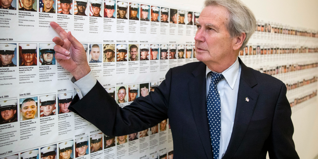 Rep. Walter Jones, seen in October 2017 with pictures of soldiers killed who were based at Camp Lejeune, N.C. (AP Photo/Andrew Harnik, File)