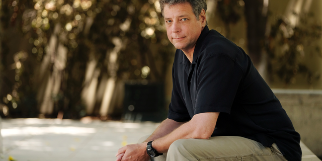 FILE - In this June 20, 2018, file photo, Michael Scott Moore, author of "The Desert and the Sea: 977 Days Captive on the Somali Pirate Coast," poses for a portrait at Los Angeles Public Library in Los Angeles. Abdi Yusuf Hassan, a U.S. citizen who has been charged with kidnapping and other counts for his alleged role in the abduction of Moore. He was held for nearly three years before his family paid a ransom for his release. (AP Photo/Chris Pizzello, File)