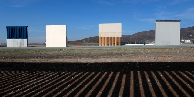 FILE - In this Wednesday, Dec. 12, 2018, file photo, border wall prototypes stand in San Diego near the Mexico-U.S. border, seen from Tijuana, Mexico, where the current wall casts a shadow in the foreground. Customs and Border Protection said Friday, Feb. 22, 2019, President Trump’s eight border-wall prototypes will be torn down to make way for a secondary barrier separating California from Mexico. (AP Photo/Moises Castillo, File)