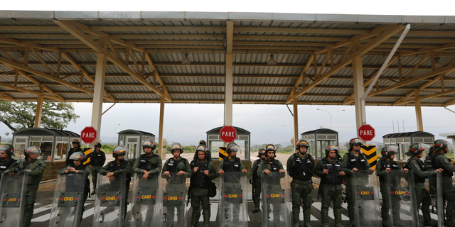 Venezuelan Bolivarian Guardsmen stand guard at the Tienditas International Bridge that links Colombia and Venezuela, near Urena, Venezuela, Friday, Feb. 8, 2019. As humanitarian aid kits were being packed into individual white bags in the city of Cucuta, just across the river from Venezuela, U.S. officials and Venezuelan opposition leaders appealed to the military to the let the aid through. (AP Photo/Fernando Llano)