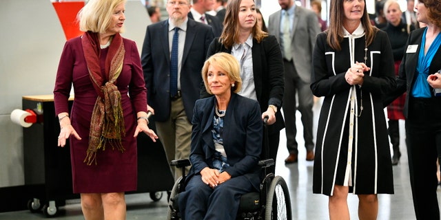 U.S. Secretary of Education Betsy DeVos, seated, tours a technical college in Florence, S.C., Thursday, Feb. 21, 2019.