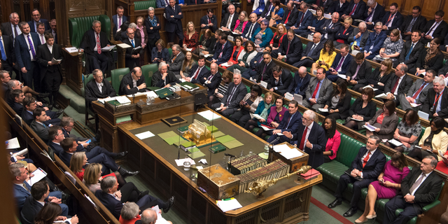 Britain's main opposition Labour Party leader Jeremy Corbyn, centre right, stands to talk to lawmakers inside parliament, London, Wednesday Feb. 27, 2019. Prime Minister Theresa May insisted Wednesday that Britain will leave the European Union on schedule next month, amid signs that her promise to give Parliament a vote on delaying Brexit was boosting support for her unpopular EU divorce deal. (Mark Duffy/UK Parliament via AP)