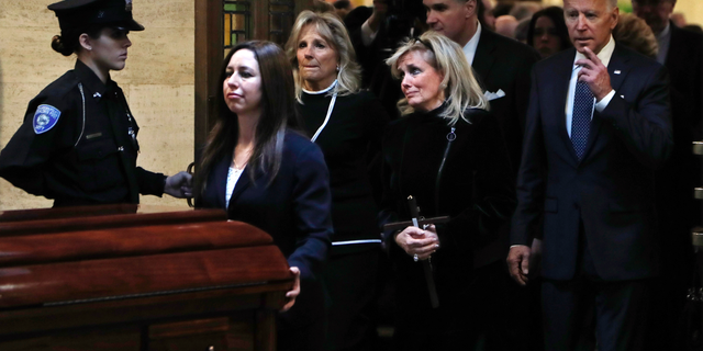 Congresswoman Debbie Dingell, center, follows the casket procession out of the Church of the Divine Child after a funeral mass for her husband John Dingell, Tuesday, Feb. 12, 2019, in Dearborn, Mich. Dingell, who represented southeast Michigan for 59 years in the House, died Thursday, Feb. 7, at age 92. (AP Photo/Carlos Osorio)