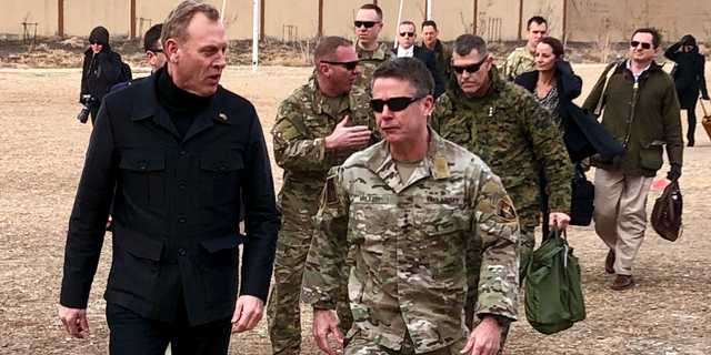 FILE - In this Feb. 11, 2019, photo, acting Defense Secretary Patrick Shanahan, left, arrives in Kabul, Afghanistan to consult with Army Gen. Scott Miller, right, commander of U.S. and coalition forces, and senior Afghan government leaders. Shanahan, the former Boeing executive, was in a familiar place, aboard an airplane, when he got word of a bolt-from-the-blue political shot across his bow. A key senator seemed to have buried Shanahan’s chances of being nominated as the next secretary of defense. The crisis passed, but it highlighted the precarious position Shanahan occupies as he waits for President Donald Trump to decide who he will successor to Jim Mattis as leader of the Pentagon. (AP Photo/Robert Burns)