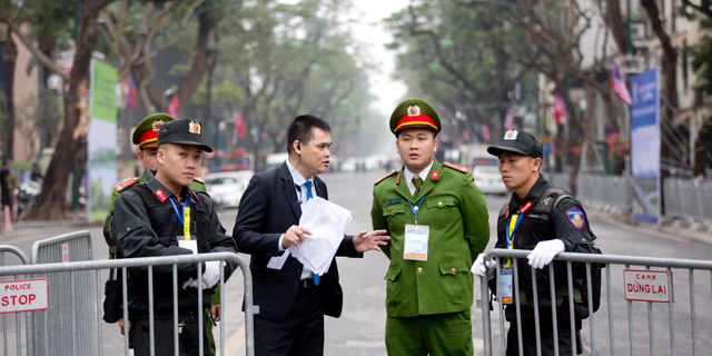 Security guards stand at a barricaded outside Melia Hotel where North Korean leader Kim Jong Un was expected to stay, in Hanoi, Vietnam, Tuesday, Feb. 26, 2019. Kim arrived in Vietnam Tuesday for his second summit with U.S. President Donald Trump. (AP Photo/Gemunu Amarasinghe)
