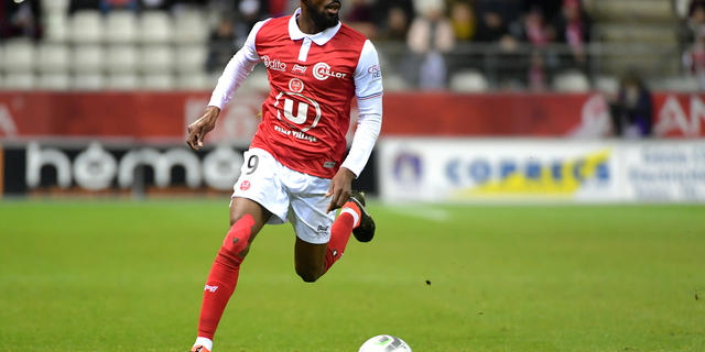 FILE - In this March 9, 2018, file photo, Reims' Anatole Ngamukol controls the ball during a league II soccer match against Chateauroux in Reims, eastern France. French soccer players are turning to the courts to fight workplace bullying and the practice known in France by an English word, "le loft." (AP Photo/Christian Lantenois, File)