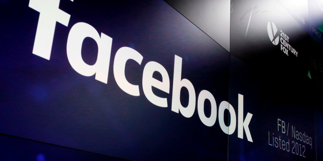 FILE- In this March 29, 2018, file photo, the logo for Facebook appears on screens at the Nasdaq MarketSite in New York's Times Square. (AP Photo/Richard Drew, File)