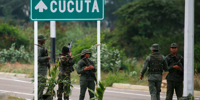Venezuelan Bolivarian Army soldiers stand guard at the Tienditas International Bridge that links Colombia and Venezuela, near Urena, Venezuela, Friday, Feb. 8, 2019. (AP Photo/Fernando Llano)