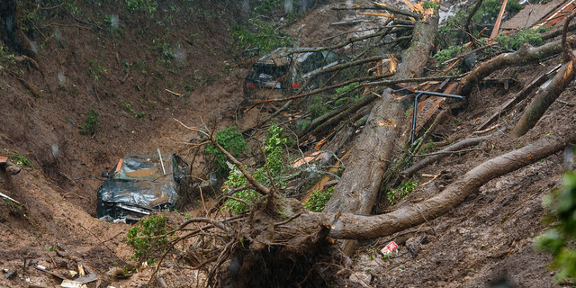Cars and a large tree are seen in a debris trail in the aftermath of a mudslide that destroyed three homes on a hillside in Sausalito, Calif., Thursday, Feb. 14, 2019. The National Weather Service says the atmospheric river sagged southward from Northern California overnight and is pointed at the southwestern corner of the state early Thursday. (AP Photo/Michael Short)