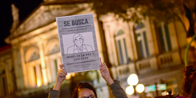 A woman holds up a sign with a line drawing depicting Costa Rica’s ex-President Oscar Arias and a message that reads in Spanish: “WANTED: Oscar Arias Nobel Peace Prize laureate and Violator”, during a protest by women activists under the slogan "Yo te creo," or "I believe you,” in San Jose, Costa Rica, Friday Feb. 8, 2019. At least five women have accused Arias of actions ranging from unwelcome fondling or sexual innuendo to sexual assault. (AP Photo/Carlos Gonzalez)