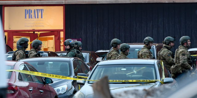 Law enforcement officers gather outside the Henry Pratt Co. manufacturing plant Friday, Feb. 15, 2019, in Aurora, Ill. Police say a gunman killed several people and injured police officers before he was fatally shot. (AP Photo/Matt Marton)