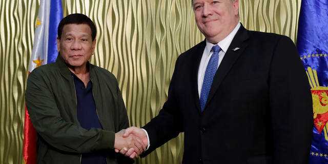 Philippine President Rodrigo Duterte, left, greets U.S. State Secretary Mike Pompeo upon arrival at Villamor Air Base in suburban Pasay city southeast of Manila, Philippines, Thursday, Feb. 28, 2019. Pompeo, who joined U.S. President Donald Trump in the second summit with North Korean leader Kim Jong-un in Vietnam, is here for talks on the two countries' relations as well as the mutual defense treaty. (AP Photo/Bullit Marquez, POOL)