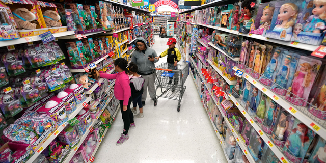 FILE- In this Nov. 9, 2018, file photo shoppers look at toys at a Walmart Supercenter in Houston. Walmart Inc. reports financial results Tuesday, Feb. 19, 2019. (AP Photo/David J. Phillip, File)