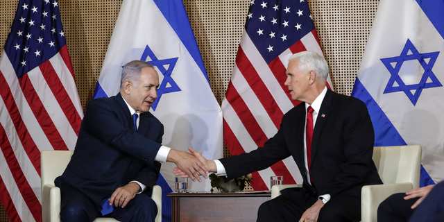 United States Vice President Mike Pence, right, shakes hands with Israeli Prime Minister Benjamin Netanyahu at a bilateral meeting in Warsaw, Poland, Thursday, Feb. 14, 2019. The Polish capital is host for a two-day international conference on the Middle East, co-organized by Poland and the United States. (AP Photo/Michael Sohn)