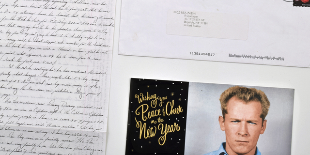 This photo provided by Urban Culture Auctions in West Palm Beach, Fla., shows a hand-written letter by the late mobster James "Whitey" Bulger, an envelope and a holiday greeting card emblazoned with his 1959 Alcatraz mugshot, that Bulger mailed from federal prison in Coleman, Fla., in 2015. The items are among those being offered by the auction house for auction on Sunday, Feb. 24, 2019. Bulger was found dead in a wheelchair on Oct. 30, 2018, killed by inmates within hours of his transfer to a prison in Hazelton, W.V. He was 89. (Darin Rone/Urban Culture Auctions via AP)