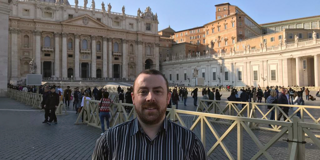 Vincent Doyle, of advocacy group Coping International, poses for a photo during an interview with The Associated Press, in St. Peter's Square at the Vatican, Wednesday, Feb. 20, 2019. The lead organizer of the Vatican's sex abuse summit Archbishop Charles Scicluna met with Doyle, the child of a priest and campaigner seeking to draw attention to another, related issue the Vatican has long sought to keep quiet: the plight of children of priests. (AP Photo/Nicole Winfield)