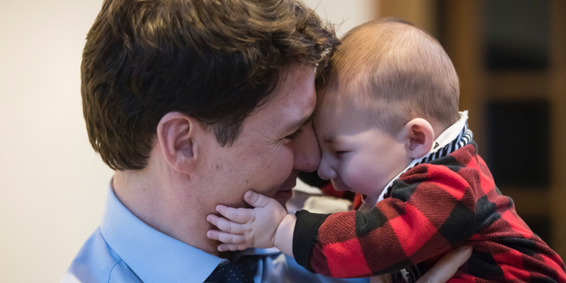 Prime Minister Justin Trudeau holds Jack Golden, six-months-old, while campaigning with Richard T. Lee, the Liberal candidate in the Burnaby South byelection, at a cafe in Burnaby, British Columbia, Monday, Feb. 11, 2019. Federal byelections will be held on Feb. 25 in three vacant ridings - Burnaby South, where NDP Leader Jagmeet Singh is hoping to win a seat in the House of Commons, the Ontario riding of York-Simcoe and Montreal's Outremont. (Darryl Dyck/The Canadian Press via AP)