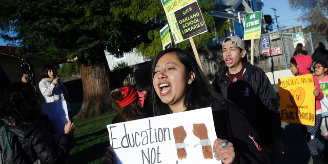 Roxana De La O Cortez, teacher at Manzanita SEED Elementary School, marches with other teachers and supporters in Oakland, Calif., Thursday, Feb. 21, 2019. Teachers in Oakland went on strike Thursday in the country's latest walkout by educators over classroom conditions and pay. (AP Photo/Jeff Chiu)