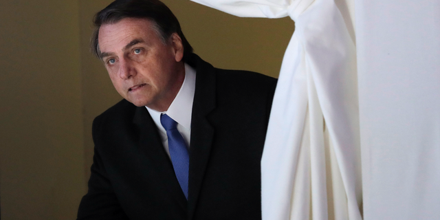 FILE - In this Jan. 22, 2019 file photo, Brazil's President Jair Bolsonaro enters the stage at the World Economic Forum, in Davos, Switzerland. Bolsonaro remains in the semi-intensive unit of a hospital in Sao Paulo with signs of a possible pneumonia infection, the Albert Einstein Hospital said in a statement Thursday, Feb. 7, 2019. (AP Photo/Markus Schreiber, File)