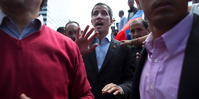 CORRECTS SPELLING OF GUAIDO - Venezuela's self-proclaimed interim president Juan Guaido walks into the crowd after he addressed transportation workers during a demonstration of support for him in Caracas, Venezuela, Wednesday, Feb. 20, 2019. Venezuela is gripped by a historic political and economic crisis despite having the world’s largest proven oil reserves. (AP Photo/Ariana Cubillos)