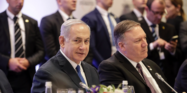 Israeli Prime Minister Benjamin Netanyahu, left, sits beside United State Secretary of State Mike Pompeo, right, at a conference on Peace and Security in the Middle East in Warsaw, Poland, Thursday, Feb. 14, 2019. The Polish capital is host for a two-day international conference, co-organized by Poland and the United States. (AP Photo/Michael Sohn)