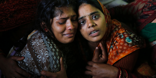 Sanju, right, and Sanjana, wife and sister respectively of paramilitary soldier Mahesh Yadav, who was killed in Thursday's explosion in Kashmir, mourn at their home in Tudihar, some 56 kilometers east of Prayagraj, Uttar Pradesh state, India, Saturday, Feb. 16, 2019. The death toll from a car bombing on a paramilitary convoy in Indian-controlled Kashmir has climbed to at least 40, becoming the single deadliest attack in the divided region's volatile history, security officials said Friday. (AP Photo/ Rajesh Kumar Singh)