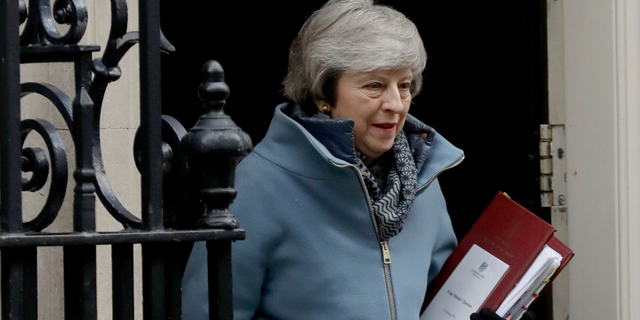 British Prime Minister Theresa May leaves 10 Downing Street in London, to attend Prime Minister's Questions at the Houses of Parliament, Wednesday, Feb. 13, 2019. (AP Photo/Matt Dunham)