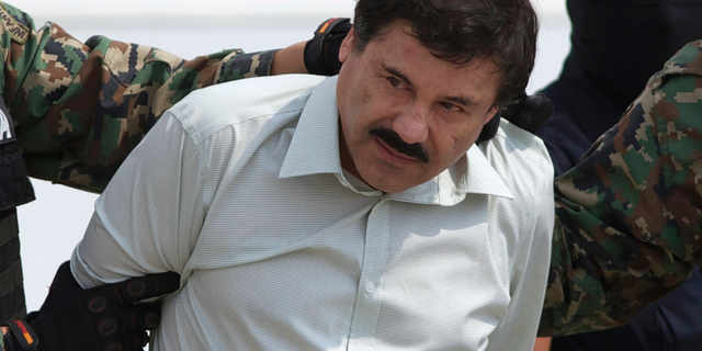 This Feb. 22, 2014 file photo shows Joaquin "El Chapo" Guzman, the head of Mexico's Sinaloa Cartel, being escorted to a helicopter in Mexico City following his capture in the beach resort town of Mazatlan.