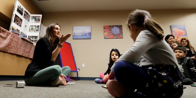 In this Jan. 23, 2019, photo, Bahareh Hedyahe leads Persian story time at Irvine public library in Irvine, Calif. It's been four decades since the Iranian revolution overthrew the ruling shah, prompting tens of thousands of Iranian exiles and refugees to make their lives in the United States. Years later, they have set down roots here and are finding ways to pass their love of Iranian culture to their American children and grandchildren. (AP Photo/Chris Carlson)