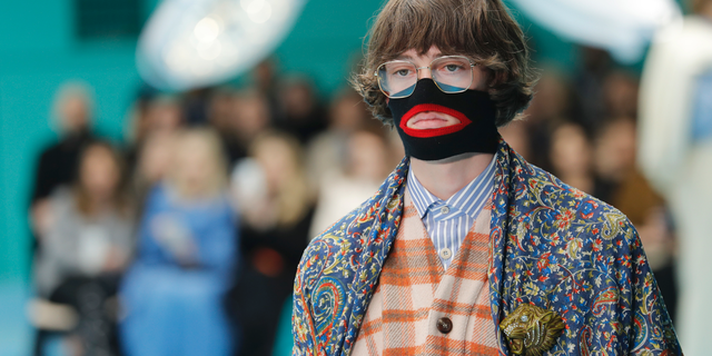 FILE - In this Feb. 21, 2018, file photo, a model wears a creation as part of the Gucci women's Fall/Winter 2018-2019 collection, presented during the Milan Fashion Week, in Milan, Italy. Gucci, which designed this face warmer, reminiscent of blackface prompted an instant backlash from the public and forced the company to apologize publicly on Wednesday, Feb. 6, 2019. (AP Photo/Antonio Calanni, File)