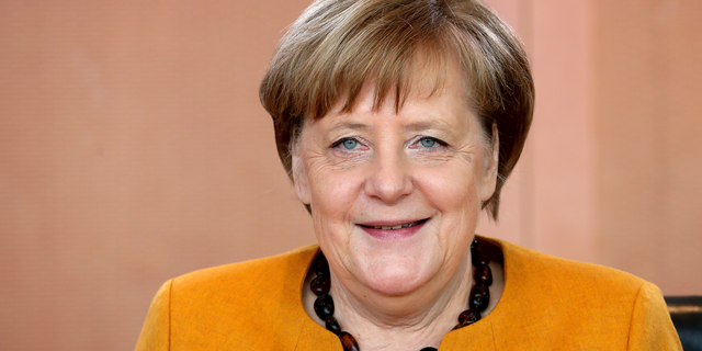 German Chancellor Angela Merkel smiles as she arives for the weekly cabinet meeting at the Chancellery in Berlin, Germany, Wednesday, Feb. 27, 2019. (AP Photo/Michael Sohn)