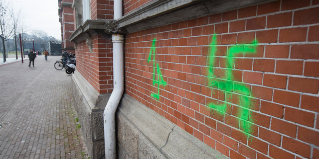 A Swastika, painted on the wall of the Stedelijk Museum overnight, is seen in Amsterdam, Netherlands, Friday, Feb. 22, 2019. Vandals suspected of being football hooligans from The Hague have daubed graffiti including swastikas and anti-Semitic texts on buildings in Amsterdam. The graffiti were discovered Friday, ahead of a match Sunday between ADO and Amsterdam powerhouse Ajax. Ajax fans are banned from attending the match following previous clashes between fans of the two clubs. (AP Photo/Peter Dejong)