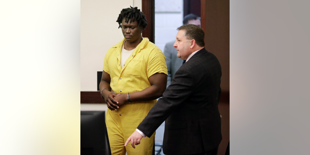 Emanuel Samson, left, enters the courtroom for a hearing Wednesday, Feb. 20, 2019, in Nashville, Tenn. Samson is accused of fatally shooting a woman and wounding six other people at a Tennessee church in September 2017. (AP Photo/Mark Humphrey)