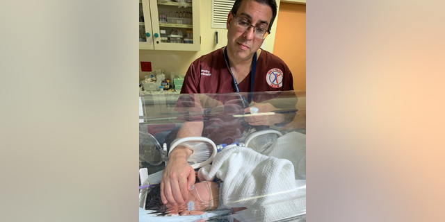 Doctor Timothy Hardcastle treats a newborn baby in a hospital after she was rescued from a storm water pipe in Durban, South Africa, Monday, Feb. 11, 2019. (AP Photo)