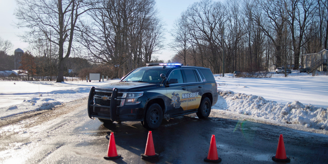 Kent County Sheriff personnel investigate the scene of a fatal shooting near the corner of 19 Mile NE and Division Avenue NE at a property on Monday, Feb. 18, 2019, near Cedar Springs, Mich. WOOD-TV reports Kent County Sheriff Michelle LaJoye-Young says authorities discovered the victims at a property near Cedar Springs, a community about 30 miles north of Grand Rapids. (Neil Blake/MLive.com/The Grand Rapids Press via AP)