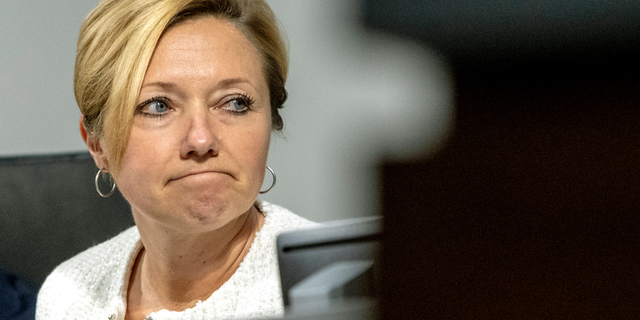In this Tuesday, Feb. 26, 2019 photo, Mayor Rosalynn Bliss reacts to protestors during a Grand Rapids City Commission meeting in Grand Rapids, Mich. Civil rights groups allege Grand Rapids police officials acted on racial profiling not fear of terrorism when they called federal immigration authorities on a former U.S. Marine who is Latino. Jilmar Ramos-Gomez was arrested in November 2018 after setting a small fire inside Spectrum Health Butterworth Hospital and then standing on the rooftop helipad. He was later held for three days by U.S. Immigration and Customs Enforcement, even though he was arrested with a U.S. passport. Grand Rapids Interim Police Chief David Kiddle said his department acted properly. (Cory Morse/The Grand Rapids Press via AP)