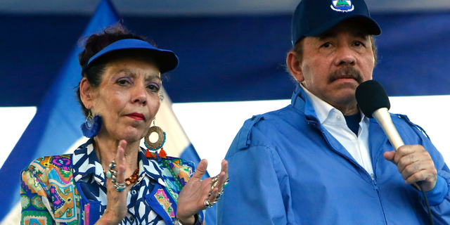FILE - In this Sept. 5, 2018 file photo, Nicaragua's President Daniel Ortega and his wife, Vice President Rosario Murillo, lead a rally in Managua, Nicaragua. Despite the new Feb. 1, 2019 tax rises, Nicaragua has not seen a repeat of last year’s mass protests. And it seems unlikely to, since Ortega forcefully quashed the challenge to his power, including effectively outlawing opposition demonstrations since September. (AP Photo/Alfredo Zuniga, File)