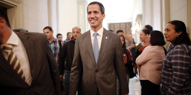 Venezuela' self proclaimed interim president Juan Guaido smiles as he arrives at the National Assembly, in Caracas, Venezuela, Wednesday, Feb. 13, 2019. Guaido said Wednesday that the National Assembly has appointed six executives to a transitional board for its PDVSA state-owned oil company and its U.S. subsidiaries, including Houston-based refiner Citgo. (AP Photo/Ariana Cubillos)